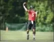  ?? GAIL BURTON — THE ASSOCIATED PRESS ?? Baltimore Ravens quarterbac­k Joe Flacco throws a pass during practice at the NFL football teams training camp in Owings Mills, MD., Thursday.