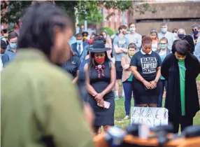  ?? PHOTOS BY MAX GERSH/THE COMMERCIAL APPEAL ?? Nattaly Perryman, a recent graduate of the Cecil C. Humphreys School of Law at the University of Memphis, bows her head as local attorney Henry Reaves leads a prayer Wednesday during the Bar Unity March in downtown Memphis.