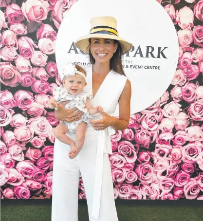  ?? ?? Amanda Abate with daughter Pia at Magic Millions People's Day.