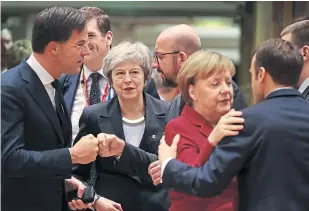  ?? Picture: Getty. ?? On the fringes: Prime Minister Theresa May watches other EU leaders greeting each other at Brussels yesterday.