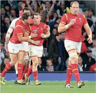  ?? AP ?? EPIC EFFORT: Wales, above celebratin­g Gareth Davies’s pivotal try on Saturday, did not give up against England, and have thrown the so-called Group of Death at the World Cup into disarray. Bottom right: Warren Gatland.
