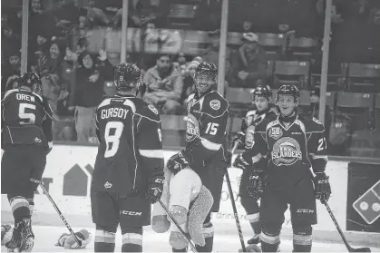  ?? JASON MALLOY/THE GUARDIAN ?? Charlottet­own Islanders captain Pierre-Olivier (P.O.) Joseph, centre, and his teammates help clean up the teddy bears from the 2018 teddy bear toss at Eastlink Centre.