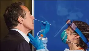  ?? — Bloomberg ?? Doing his part: Cuomo undergoing a Covid-19 test during a live news conference in albany, New york.