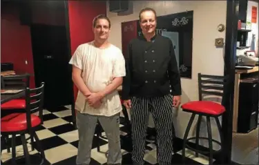  ?? MONICA SAGER — DIGITAL FIRST MEDIA ?? Mike Rohrbach, left, and Donnie Weil, right are the new owners/chefs at The Pit Stop Tavern &amp; Restaurant, 961 N. Reading Ave. in Boyertown. The restaurant, which originally opened in 1964, opened under the new ownership in May.