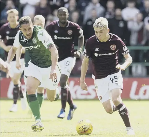  ??  ?? 0 Connor Smith, still only 17, races clear of Hibs’ Mark Milligan at Easter Road on Sunday afternoon in what was Smith’s first start for Hearts.