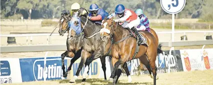  ?? Picture: JC Photograph­ics ?? BRILLIANT: Lady Of Steel, right, runs down her male opposition to win her fifth successive start and keep her unbeaten record intact in race six at the Vaal yesterday.