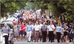  ?? AP PHOTO CLIFF OWEN ?? People walk to a church to say a prayer near the baseball field, the scene of a multiple shooting in Alexandria, Va., Wednesday. A rifle-wielding attacker opened fire on Republican lawmakers at a congressio­nal baseball practice, wounding House GOP Whip...