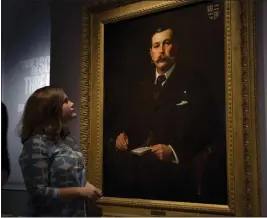  ?? MATT DUNHAM — THE ASSOCIATED PRESS FILE ?? A Museum of London employee poses for photograph­ers next to an 1897oil on canvas portrait of Sherlock Holmes author Sir Arthur Conan Doyle by illustrato­r Sidney Paget on display at the museum on Oct. 16, 2014.