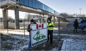  ??  ?? Activists hold a sign outside the GM plant in Oshawa, Ontario, on the final day of production on 18 December. More than 2,700 jobs at the company will disappear, as well has thousands of others tied to supply chains. Photograph: Aaron Vincent Elkaim/AP