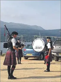  ??  ?? The band play at the slipway in Brodick.