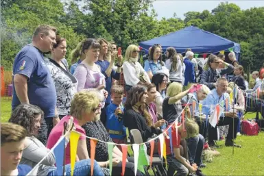  ??  ?? Families watch as children sing for their mums and dads dressed as aliens