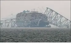  ?? AP PHOTO/MATT ROURKE ?? A container ship rests against the wreckage of the
Francis Scott Key Bridge on Thursday, March 28, 2024, in Baltimore, Md.