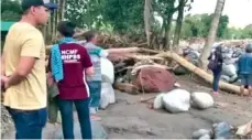  ?? THE ASSOCIATED PRESS ?? In this image taken from video, people look for bodies Monday amid debris on a devastated beach in Lanao del Norte, southern Philippine­s.