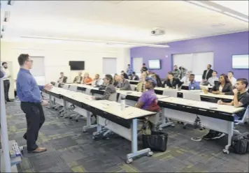  ?? Phoebe Sheehan / times union ?? Papertalk creators Luc Sandler and nueci rojas present during the Blackstone Launchpad innovation Competitio­n on friday at ualbany’s massry Center for Business in Albany.