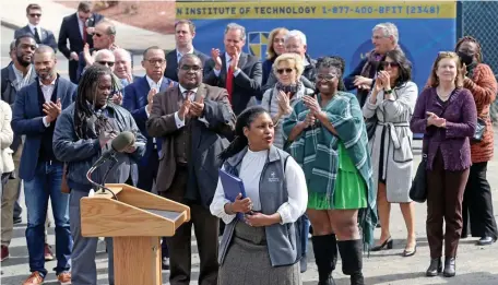  ?? MATT STONE PHOTOS / HERALD STAFF ?? NEW LOCATION: Dr. Aisha Francis, president of Benjamin Franklin Institute of Technology, speaks during an event to launch the demolition of a warehouse of the site that will become the location of the school’s new campus in Nubian Square in Roxbury. Below, Gov. Charlie Baker grabs a hammer during the demolition.