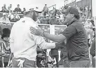  ?? ALASTAIR GRANT/ AP ?? Dustin Johnson, left, and Phil Mickelson greet each other at the inaugural LIV Golf Invitation­al in June 2022.