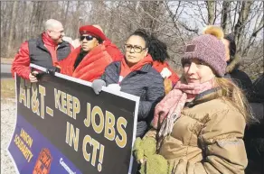  ?? Dave Zajac / Associated Press ?? AT&T employee Lucia Coelho of Prospect, right, stands with co-workers affected by the planned closure of several local AT&T call centers.