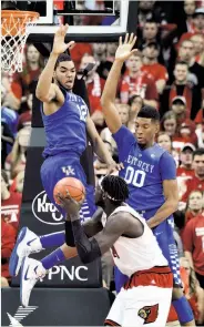  ?? Timothy D. Easley / Associated Press ?? Kentucky's Karl-Anthony Towns (left) and Marcus Lee contest a shot by Louisville's Montrezl Harrell.