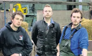  ??  ?? Stephen Hughes, 33, centre, with his brothers Sion, 32, left, and Geraint, 27, at the family farm on Anglesey, where their father Elfed Hughes, 56, took his own life