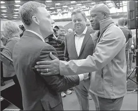  ?? NWA Democrat-Gazette/ANDY SHUPE ?? Chad Morris (left), Arkansas’ new football coach, meets Razorbacks men’s basketball coach Mike Anderson (right) as agent Jimmy Sexton looks on after Thursday’s news conference in Fayettevil­le.