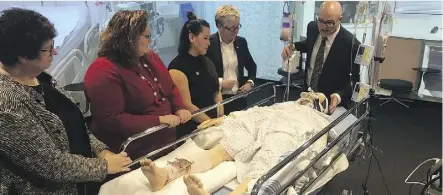  ?? MRU ?? Dr. Murray Holtby, right, demonstrat­es on a training mannequin on Friday at Mount Royal University in Calgary, where new rules allowing expanded roles for some registered nurses were announced.