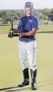  ?? MICHAEL THOMAS, THE ASSOCIATED PRESS ?? Andrew Landry shows off the trophy and cowboy boots awarded the winner on Sunday.