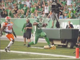  ?? The Canadian Press ?? Saskatchew­an Roughrider­s running back Cameron Marshall (32) scores a touchdown during first-half CFL action against the B.C. Lions in Regina on Sunday.