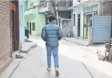  ?? ?? Surya Sharma, who joined the Russian army as a mercenary to fight in the invasion of Ukraine and asked to use a pseudonym for legal reasons, walks along a street in Kathmandu.