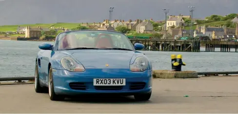  ??  ?? Right The Boxster taking time out on Stormness quay, Hoy in the background