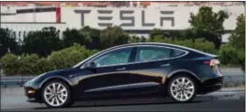  ?? COURTESY OF TESLA MOTORS VIA AP ?? Tesla Motors Model 3 sedan is half the cost of previous models. Its $35,000 starting price and 215-mile range could bring hundreds of thousands of customers into Tesla’s fold, taking it from a niche luxury brand to the mainstream.