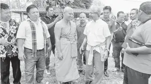  ?? — Gambar Bernama ?? APA KHABAR?: P Waythamoor­thy (depan, dua kanan) beramah mesra dengan sami pada Program Bersama Komuniti Siam di Wat Siam Kampung Lampam dekat Pedang, semalam.