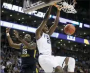  ?? CHARLES KRUPA — THE ASSOCIATED PRESS ?? Villanova’s Dhamir Cosby-Roundtree, right, dunks in front of West Virginia’s Lamont West during the first half of Friday’s regional semifinal in Boston.