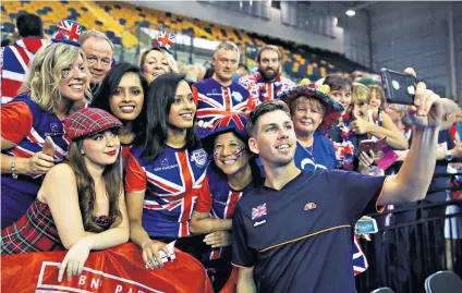  ??  ?? Flying the flag: Cameron Norrie poses for a selfie with jubilant fans after winning the tie for Britain yesterday