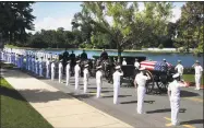  ?? David Hume Kennerly / Associated Press ?? In this photo provided by McCain family, the horse-drawn caisson bearing the body of Sen. John McCain, R-Ariz., moves through the grounds of the United Sates Naval Academy toward the cemetery after a service in the chapel on Sunday in Annapolis, Md.