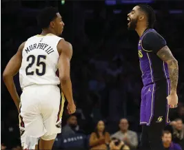  ?? RONALD MARTINEZ — GETTY IMAGES ?? The Lakers' D'Angelo Russell, right, reacts after making a 3-pointer in front of New Orleans' Trey Murphy III in the first half of Friday's game at at Crypto.com Arena.