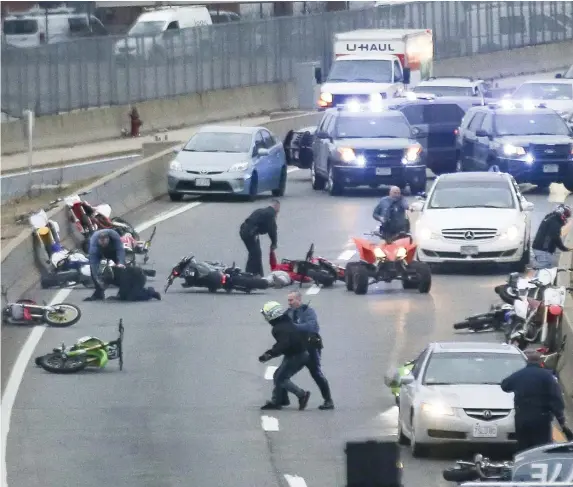  ?? Herald File photo ?? NOT GOING AWAY: State troopers mix it up with dirt bike riders on the Expressway’s southbound exit to Massachuse­tts Avenue in 2018. Dirt bike riders have continued to flout traffic laws and Mayor Michelle Wu isn’t talking about putting more police on the case.