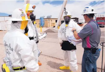  ?? SOURCE: U.S. DEPARTMENT OF ENERGY ?? Workers in protective gear prepare to enter the Waste Isolation Pilot Plant near Carlsbad on April 2, 2014. They were the first workers to enter the nuclear waste storage site after an explosion nearly two months earlier shut down the plant.