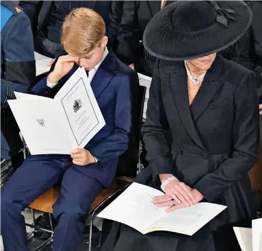 ?? ?? Brave: Nine-year-old Prince George wipes his eyes during the service