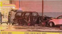  ?? 13 WHAM TV/Associated Press ?? Rochester, N.Y., firefighte­rs investigat­e the crash site after a man in an SUV loaded with gas cans sped toward a pedestrian crossing. He hit a vehicle first, killing two of its passengers.