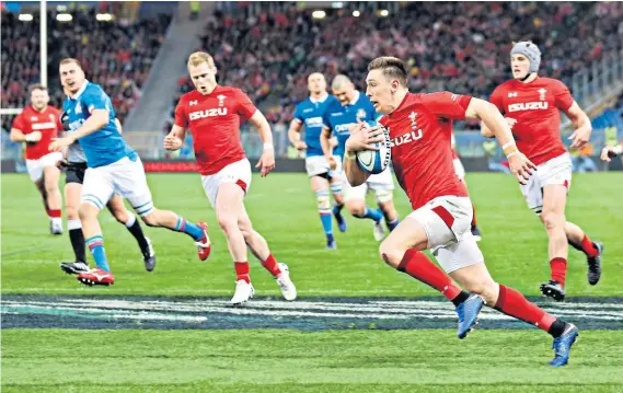  ??  ?? Calming influence: Josh Adams scores the first Wales try to halt Italy’s revival