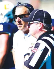  ?? STAFF PHOTO BY ROBIN RUDD ?? UTC football coach Rusty Wright discusses a call with an official during Saturday’s game against East Tennessee State University at Finley Stadium.