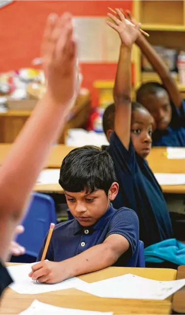  ?? Photos by Melissa Phillip / Staff photograph­er ?? Jose Pacheco, 9, works on a math problem in Debra Perdue’s third-grade class at Texas Serenity Academy. The charter school of 363 students, with 95 percent from low-income households, is housed in a church.