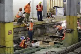  ?? RICHARD DREW — ASSOCIATED PRESS ?? Workers prepare the roadbed to place new tracks in New York’s Penn Station last week.