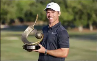  ?? MIKE CARLSON — THE ASSOCIATED PRESS ?? Paul Casey poses with the champions trophy after winning the Valspar Championsh­ip golf tournament Sunday in Palm Harbor, Fla.