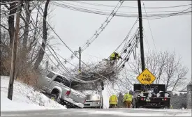  ?? TODD BERKEY / ASSOCIATED PRESS ?? A linesmen works on repairing down wires Friday in Johnstown, Pa. The storm left more than 700,000 without power in the Eastern United States.