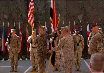  ?? AP Photo/Khalid Moham- ?? In this 2019 file photo, U.S. Army Lt. Gen. Pat White, III Armored Corps Commanding General (center left) and Commanding General for U.S. Central Command Gen. Kenneth F. McKenzie Jr. (center right) take part in a transfer authority ceremony at Union III, base in Baghdad, Iraq. med