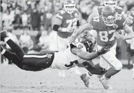  ?? CHARLIE RIEDEL THE ASSOCIATED PRESS ?? Baltimore Ravens linebacker C.J. Mosley tackles Chiefs’ Travis Kelce (87) in second-half action in Kansas City on Sunday. Harrison Butker kicked an overtime field goal for K.C., helping the Chiefs to a 27-24 victory. For more NFL coverage, see thespec.com.