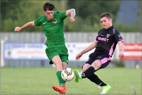  ??  ?? Cian Doyle of Wexford F.C. tries to prevent the progress of Cork City’s Jordan O’Regan in Tuesday’s cup encounter.