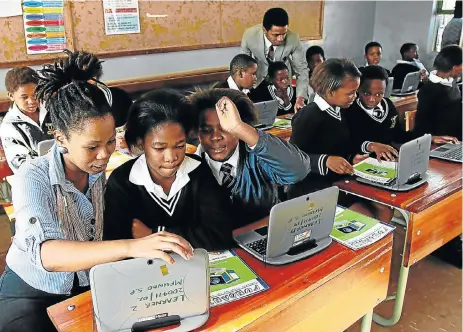  ?? Michael Pinyana ?? Unmet needs: Sinovuyo Apleni and Luthando Gubevu, founders of the Fundani education project, teach computer skills to Mfundo Senior Primary pupils in Mdantsane. The education system produces a high number of social science graduates, who are not in high demand, compared with technical and service industry skills. /
