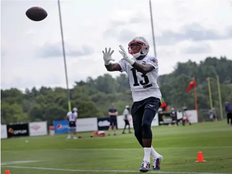  ?? NANCY LANE / HERALD STAFF FILE ?? IFFY: Nelson Agholor catches a pass during a July 29 practice. The wide receiver increased his productivi­ty during Friday’s practice session.